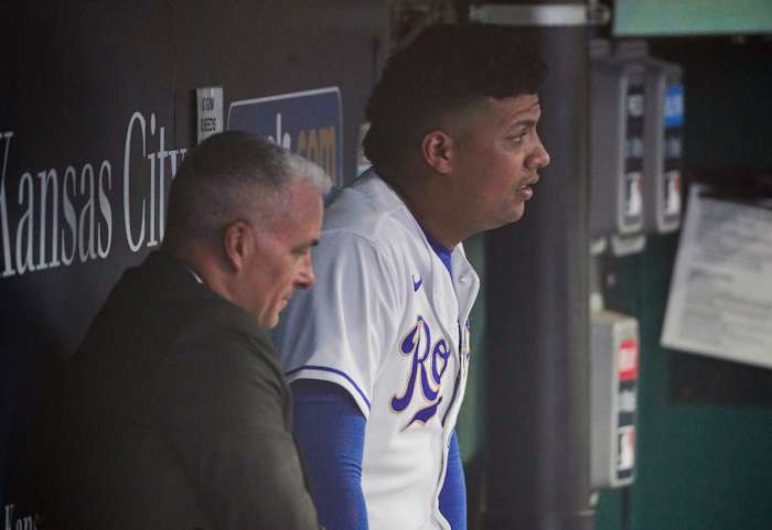 Sep 3, 2021; Kansas City, Missouri, USA; Kansas City Royals general manager Dayton Moore (left) sits with starting pitcher Carlos Hernandez (42) in the dugout while waiting out a rain delay before a game against the Chicago White Sox at Kauffman Stadium. Mandatory Credit: Denny Medley-USA TODAY Sports